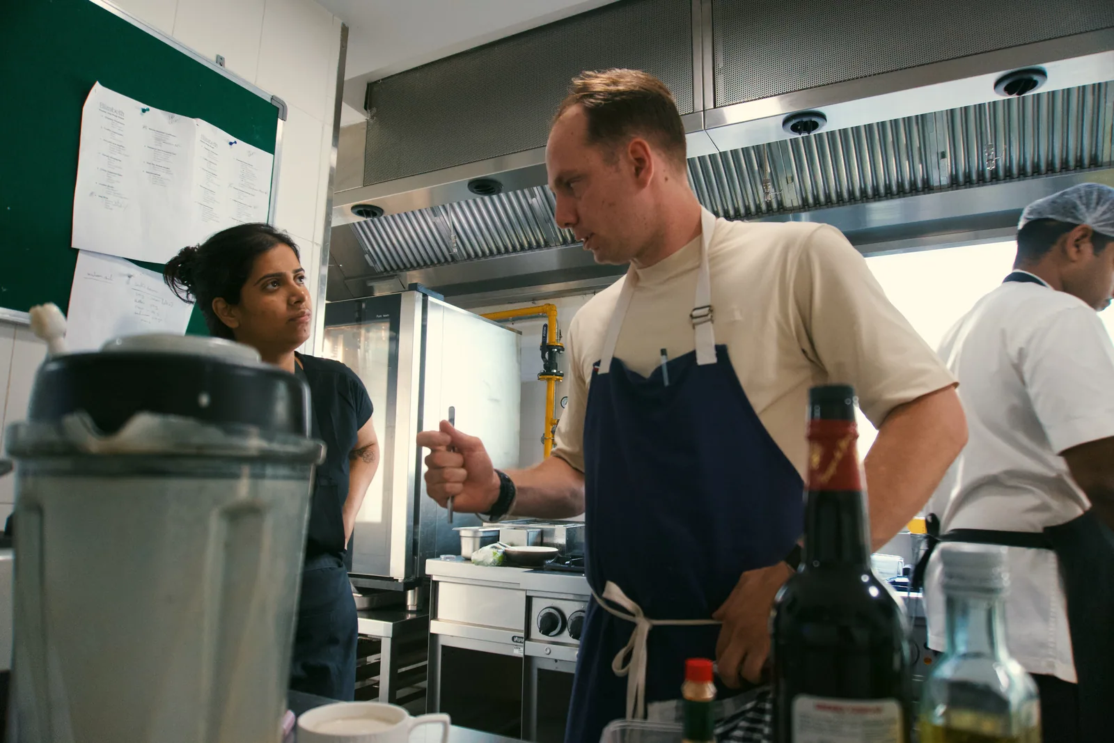 Jason talking with a chef during prep in Hyderabad