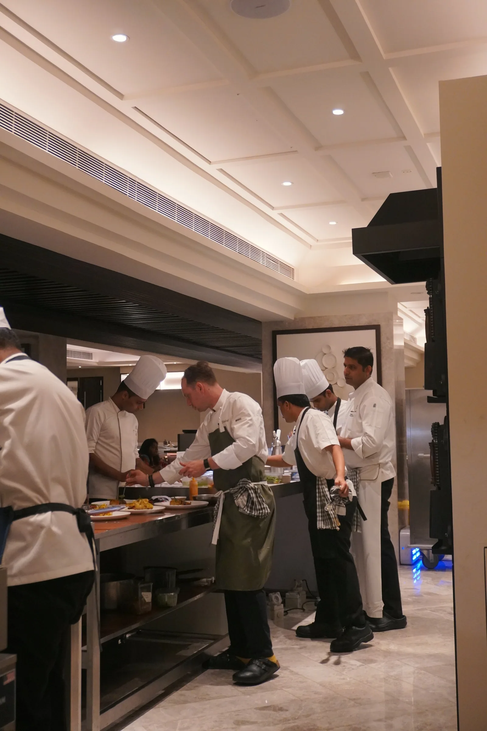 The kitchen team working along the pass in Hyderabad