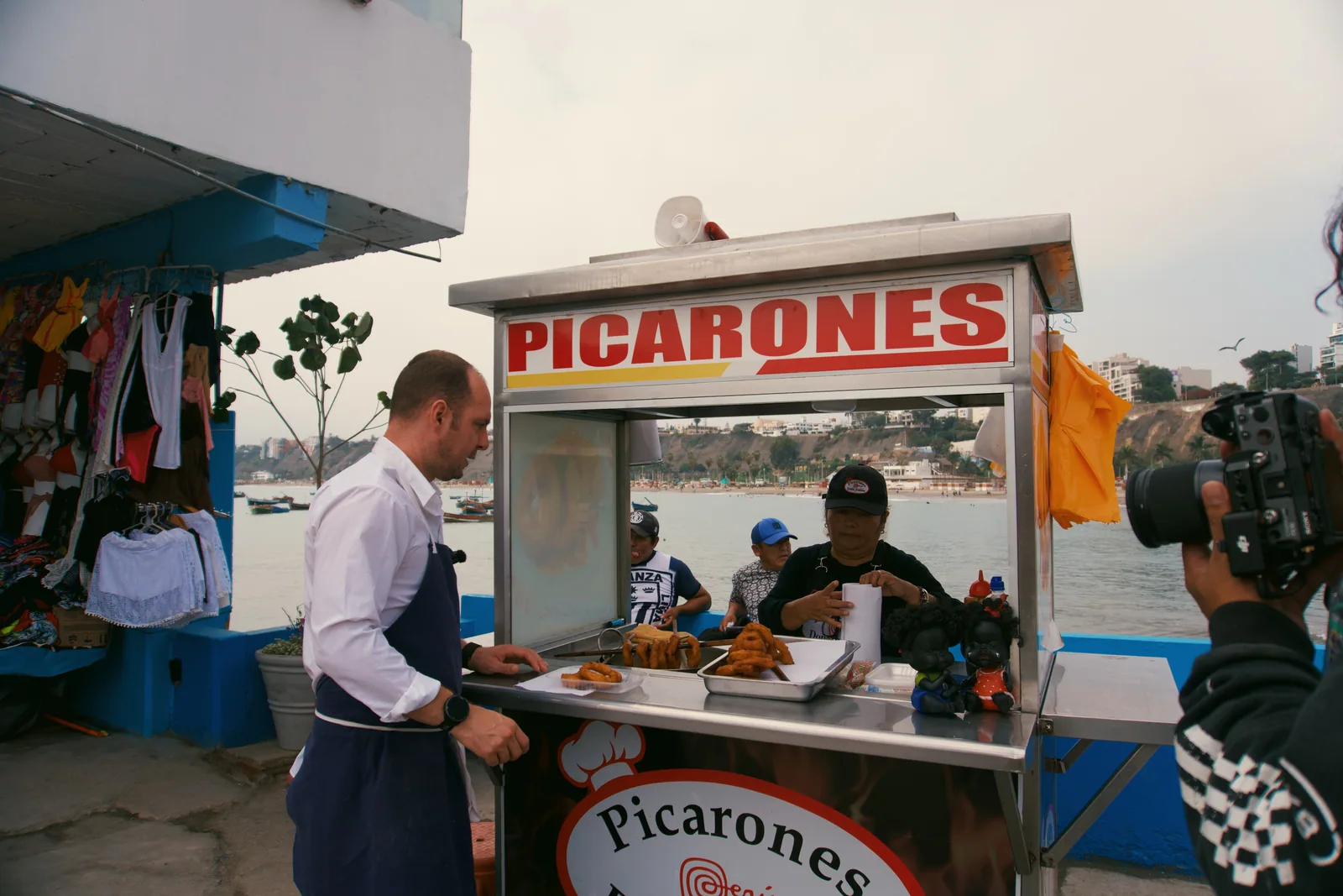 Jason talking with a vendor at a picarones cart in Peru