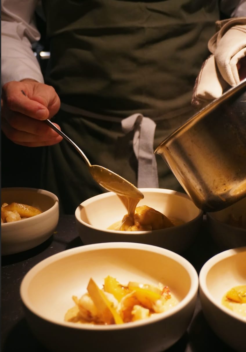 Pouring a long-cooked broth